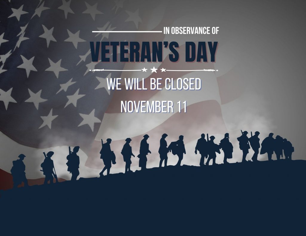 A dark blue silhouette of a troupe of soldiers marching up a hill superimposed over a faded image of an American flag. Text in a mixture of red, white, and blue reads: In observance of Veteran's Day, we will be closed November 11